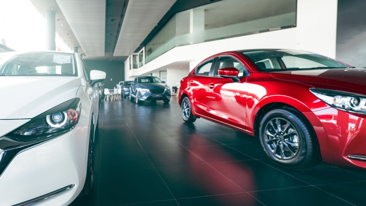 Mazda cx-5 and mazda cx-9 parked in a showroom.