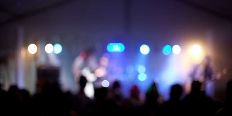 A blurry image of people at a concert.